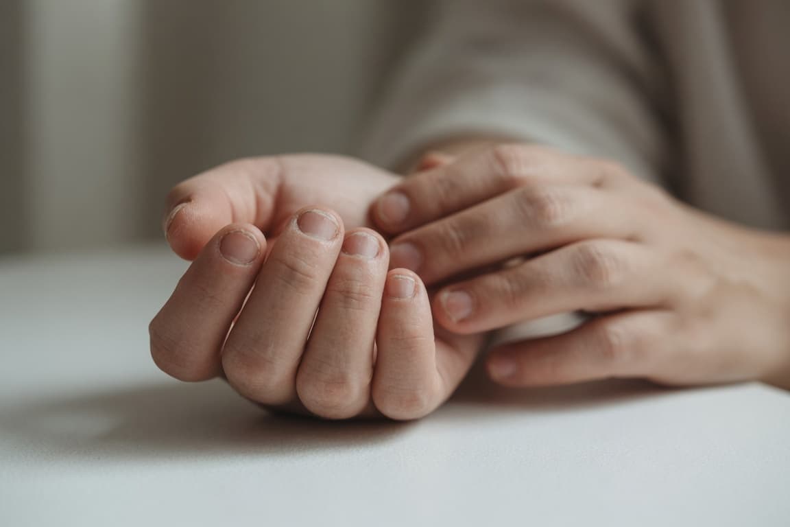 Close-up of a calm hand in soft natural light, reflecting the journey from nail biting toward healthier nails